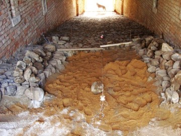 Po dvou stoletích jsou původní čedičové kameny znovu usazovány do vnitřních prostor poterny.